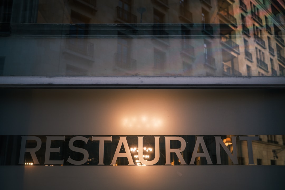 about-img-01 restaurant-sign-illuminated-at-night-with-building-reflection-7xhxxbvtroa